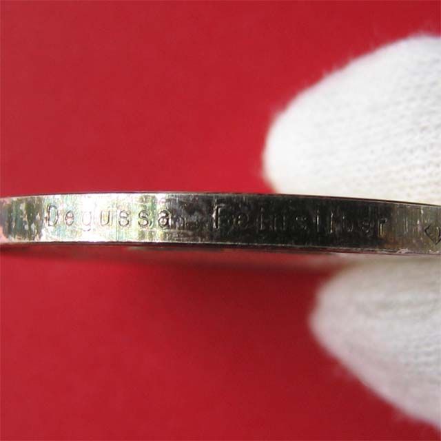 Beautiful rainbow toning near rims. Edge hallmarked  FEINSILBER