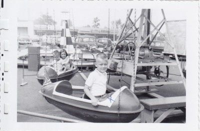   The FairChildren Flying In Circles On Little Carnival Airplane Ride